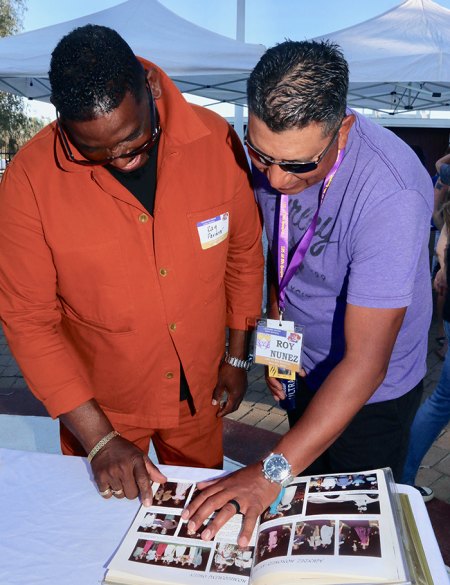 Ray Parmer and Roy Nunez look over one of a dozen yearbooks on display.